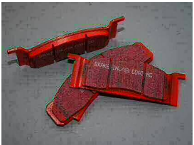 Disc brake pads. Theyre red in this image. They can be any color. 